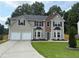 Charming two-story home featuring a two-car garage and well-manicured front lawn at 4805 Madison Point Cir, Austell, GA 30106