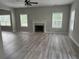 Inviting living room with a fireplace, large windows, and new flooring at 4805 Madison Point Cir, Austell, GA 30106