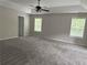 Spacious main bedroom with large windows, carpet flooring, and a ceiling fan at 4805 Madison Point Cir, Austell, GA 30106