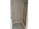 A well-lit shower stall with glass doors and neutral-colored tiling at 4805 Madison Point Cir, Austell, GA 30106