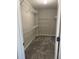 Spacious walk-in closet features ample shelving and neutral carpeting, offering efficient storage solutions at 4805 Madison Point Cir, Austell, GA 30106