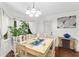 Cozy dining room with a decorative table, plants, natural light, and backyard access at 12 Ranger Se Rd, Cartersville, GA 30121