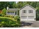 Charming home features a two-car garage, covered front porch, and lush landscaping at 12 Ranger Se Rd, Cartersville, GA 30121