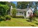 Quaint home with a cozy front porch, beautiful landscaping, and green lawn at 12 Ranger Se Rd, Cartersville, GA 30121