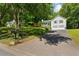 View of the home with landscaped lawn, driveway, and mature trees at 12 Ranger Se Rd, Cartersville, GA 30121