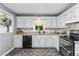 Updated kitchen featuring granite countertops, backsplash, and black appliances at 12 Ranger Se Rd, Cartersville, GA 30121