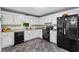 Updated kitchen with white cabinets, black appliances, granite countertops, and stylish backsplash at 12 Ranger Se Rd, Cartersville, GA 30121