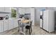 Kitchen features white cabinets, modern appliances, a window view, and a dining area at 12 Ranger Se Rd, Cartersville, GA 30121