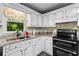 Updated kitchen featuring granite countertops, backsplash, and black appliances at 12 Ranger Se Rd, Cartersville, GA 30121