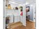 Functional laundry room with storage shelves, modern washer and dryer, and hardwood floors at 12 Ranger Se Rd, Cartersville, GA 30121