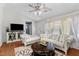 Bright living room featuring hardwood floors, white walls, and large windows with elegant sheer curtains at 12 Ranger Se Rd, Cartersville, GA 30121