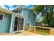 Lovely backyard deck extending from a blue home with a sliding glass door entry at 1328 Hoy Taylor Dr, Norcross, GA 30093