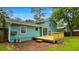 Backyard view of teal-colored house with new wood deck and fence at 1328 Hoy Taylor Dr, Norcross, GA 30093