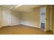 Finished basement room with tile floors, neutral paint, and doorway at 1328 Hoy Taylor Dr, Norcross, GA 30093