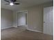 Bright bedroom featuring ceiling fan, mirrored closet and window with lots of natural light and neutral paint scheme at 1328 Hoy Taylor Dr, Norcross, GA 30093