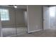Bright bedroom featuring mirrored closet and window with lots of natural light and neutral paint scheme at 1328 Hoy Taylor Dr, Norcross, GA 30093
