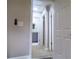 Hallway with access to bathroom and other rooms with neutral paint scheme and carpet at 1328 Hoy Taylor Dr, Norcross, GA 30093