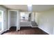 Open living room with wood floors, and steps to a landing and open kitchen view at 1328 Hoy Taylor Dr, Norcross, GA 30093