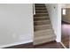 Carpeted staircase leads to the upper level, blending seamlessly with the home's neutral color palette at 1328 Hoy Taylor Dr, Norcross, GA 30093