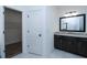 Modern bathroom with granite vanity and large mirror at 2113 Ella Springs Dr, Covington, GA 30014