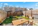 Private backyard with artificial turf, wooden fence, and patio seating area at 2309 Rolling Trl, Lithonia, GA 30058
