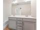 Bathroom featuring a double sink vanity with sleek fixtures and a large mirror in a neutral color palette at 2309 Rolling Trl, Lithonia, GA 30058