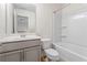 Bathroom features a white single sink vanity, matching toilet and tub with shower, and neutral flooring at 2309 Rolling Trl, Lithonia, GA 30058