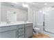 Bright bathroom with double sink vanity, a large mirror, modern lighting, and a glass enclosed shower at 2309 Rolling Trl, Lithonia, GA 30058