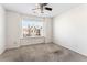 Neutral bedroom with carpet, a ceiling fan, and a window that provides natural light at 2309 Rolling Trl, Lithonia, GA 30058