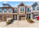 Charming townhome with stone accents, well-maintained landscaping, and attached garages at 2309 Rolling Trl, Lithonia, GA 30058