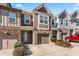 Charming townhome with stone accents, well-maintained landscaping, and attached garages at 2309 Rolling Trl, Lithonia, GA 30058