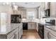 Well-lit kitchen featuring granite countertops, stainless steel appliances, and ample cabinet space at 2309 Rolling Trl, Lithonia, GA 30058