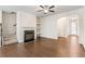 Open-concept living room featuring a fireplace, hardwood floors, and neutral decor at 2309 Rolling Trl, Lithonia, GA 30058