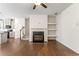 Open-concept living room featuring a fireplace, hardwood floors, and neutral decor at 2309 Rolling Trl, Lithonia, GA 30058