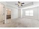 Main bedroom with carpet, tray ceiling, walk-in closet and ensuite bathroom at 2309 Rolling Trl, Lithonia, GA 30058