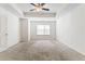 Main bedroom with carpet and tray ceiling, featuring a window that provides natural light at 2309 Rolling Trl, Lithonia, GA 30058