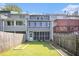 Backyard featuring a well-maintained lawn, fenced perimeter, and established garden beds for outdoor enjoyment at 3244 Hampton Se Ct, Smyrna, GA 30082