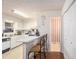 Functional kitchen with white cabinets, bar seating, and essential appliances at 3244 Hampton Se Ct, Smyrna, GA 30082