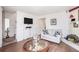 Cozy living room with hardwood floors, a comfortable sofa, and a decorative fireplace at 3244 Hampton Se Ct, Smyrna, GA 30082