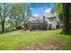 Expansive backyard featuring a lush lawn, wooden deck, and mature trees creating a serene outdoor space at 1027 Regency Dr, Acworth, GA 30102