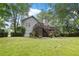 Inviting backyard with a two-story deck, established landscaping, and lush lawn, perfect for outdoor living at 1027 Regency Dr, Acworth, GA 30102