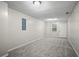 Spacious basement area with gray carpet, light-colored walls, and ample lighting at 1027 Regency Dr, Acworth, GA 30102