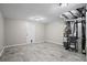 A spacious basement with vinyl flooring, a white door, and a Goodman HVAC system at 1027 Regency Dr, Acworth, GA 30102