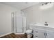 Bathroom with a shower, toilet, white vanity with a sink, and dark wood-look floors at 1027 Regency Dr, Acworth, GA 30102