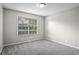 Bedroom with gray carpet, neutral paint, and a large window that offers plenty of natural light at 1027 Regency Dr, Acworth, GA 30102