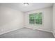 Bedroom with gray carpet, neutral paint, and a window with backyard view providing natural light at 1027 Regency Dr, Acworth, GA 30102