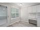 Cozy breakfast nook featuring a window, a back door, and white cabinets with subway tile backsplash at 1027 Regency Dr, Acworth, GA 30102