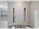 Bright foyer with a white front door, side windows, and light gray walls, leading into the home at 1027 Regency Dr, Acworth, GA 30102