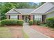 Inviting front entrance featuring a brick facade, manicured landscaping, and a clear walkway leading to the door at 1027 Regency Dr, Acworth, GA 30102