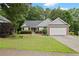 Charming ranch-style home with a well-maintained lawn, brick accents, and an attached two-car garage at 1027 Regency Dr, Acworth, GA 30102